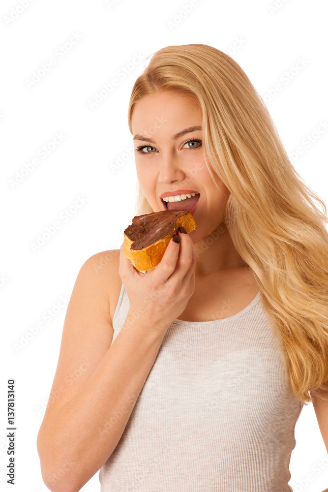 Young blond woman eating breakfast bread and nougat spread isolated over white background Young blond woman eating breakfast bread and nougat spread isolated over white background