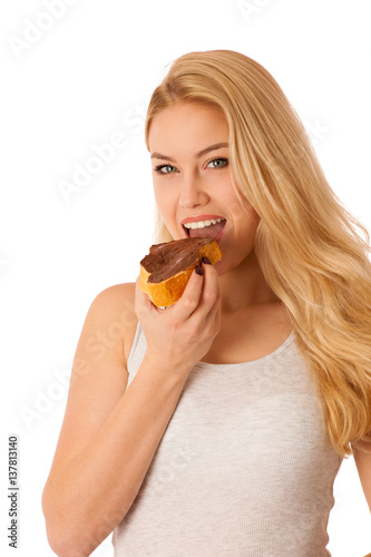 Young blond woman eating breakfast bread and nougat spread isolated over white background