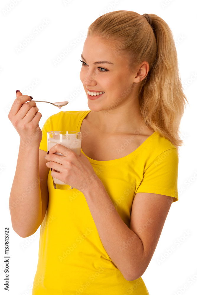 Cute blonde woman eating fruit yogurt isolated over white background Cute blonde woman eating fruit yogurt isolated over white background