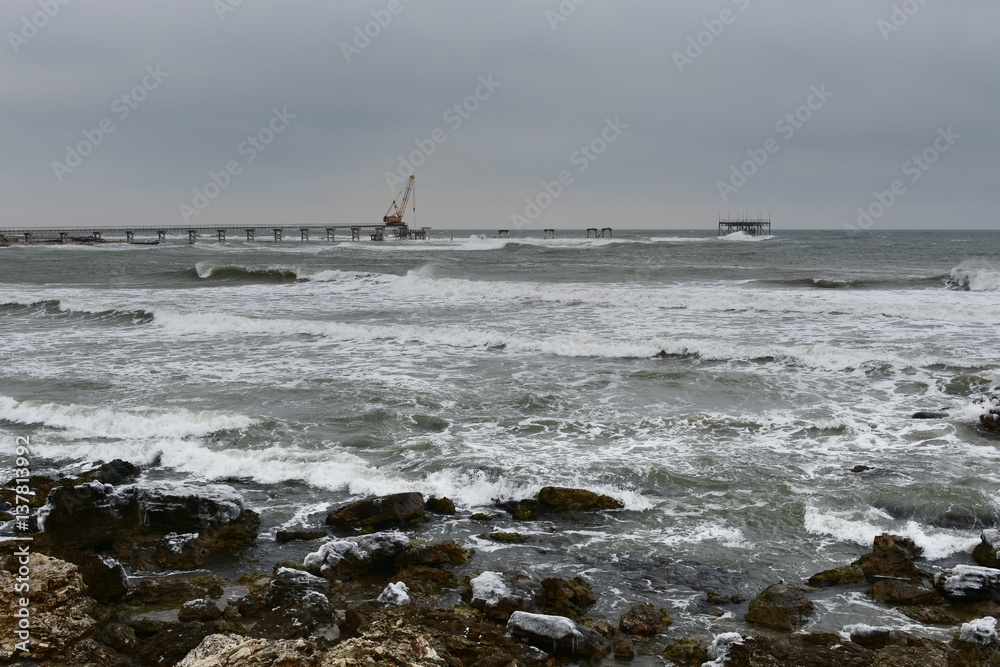 Cape Shabla, Black Sea, Bulgaria in a cold winter day. Building a new oil rig on the place of the ruined old one