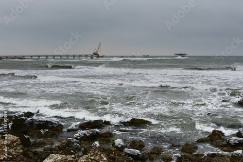 Cape Shabla, Black Sea, Bulgaria in a cold winter day. Building a new oil rig on the place of the ruined old one photo