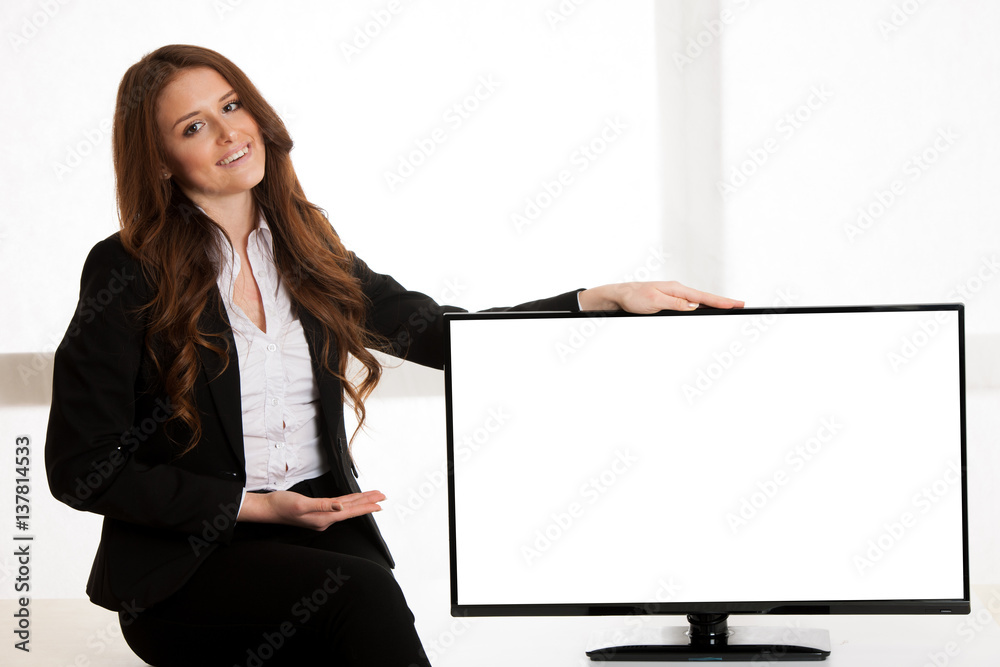 Beautiful business woman pointing to large screen with blank white copyspace for advertisement Beautiful business woman pointing to large screen with blank white copyspace for advertisement