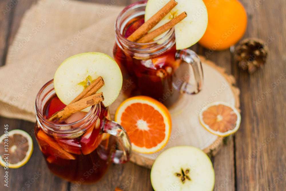 Mulled wine in glass mug with spices and citrus fruit Mulled wine in glass mug with spices and citrus fruit