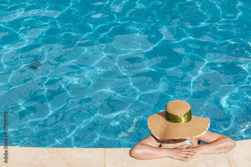 Woman enjoying suntan at the swimming pool