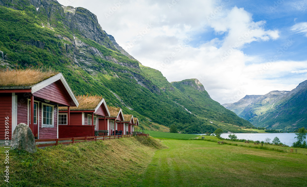 Red cabins with grass on the roofs, Norway