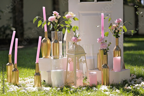 Beautifully composition of candles andred flowers photo