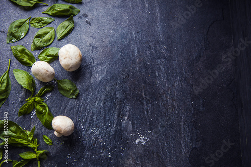 basil leaves on food background with mushrooms