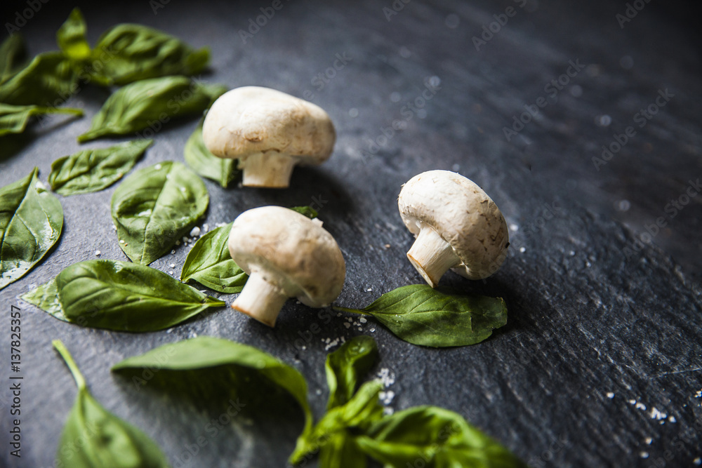basil leaves on food background with mushrooms basil leaves on food background with mushrooms