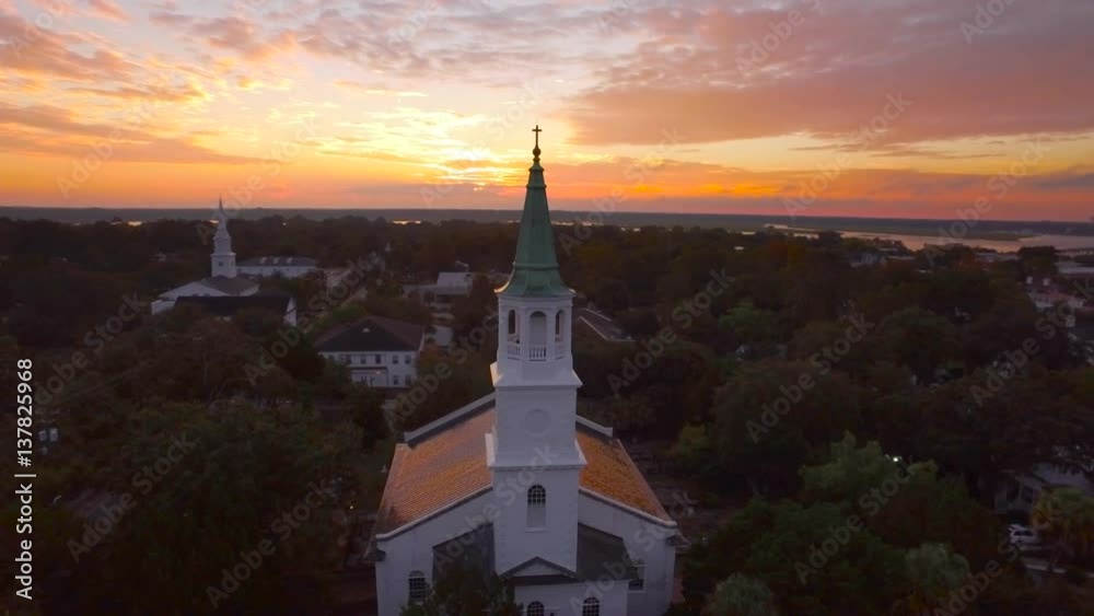 4k Aerial of historic cathedral, church at bright orange sunrise in Beaufort South Carolina 