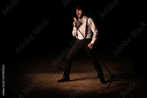 Singer with microphone and black background