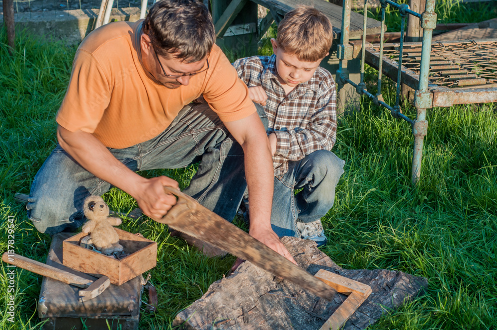 Father and son working with tools outdoor