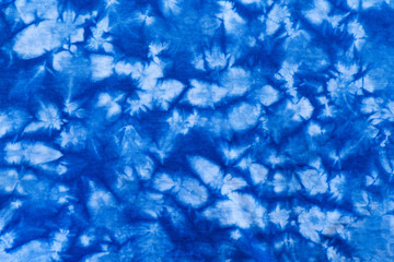 Pattern of blue tie batik dye on cotton cloth, Dyed indigo fabric background and textured, Painted blue watercolor on white cotton cloth