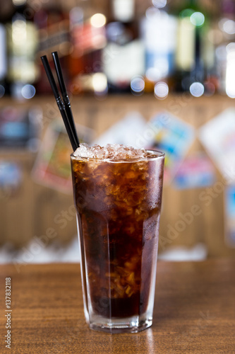 alcohol cocktail on wooden bar with bar background