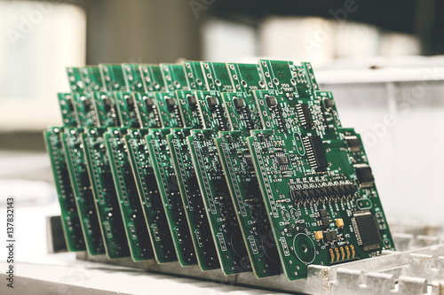 Computer board with chips at the factory for the production of computer components. photo