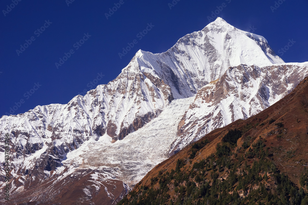 Daulagiri summit view with glacier and blue sky background. Nepal landscape, Annapurna circuit, Himalaya mountains, Asia