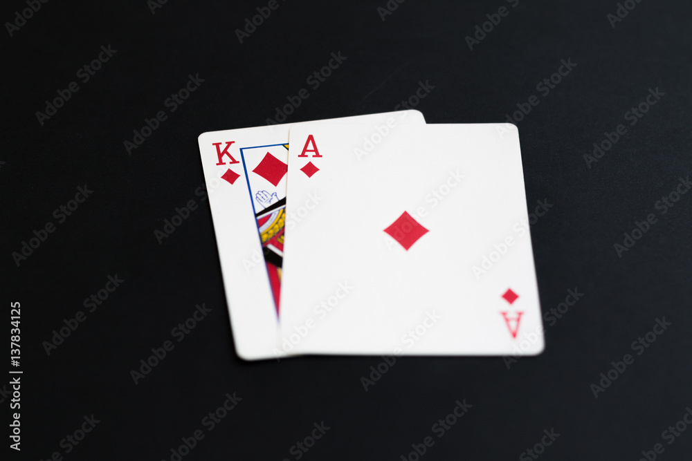 Playing poker cards ace king on black background