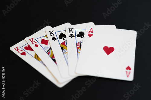 Four of a kind in poker cards game on a black background