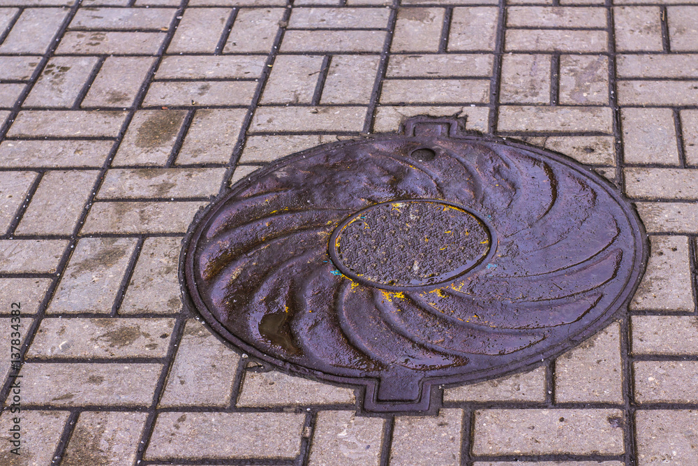sewer and drainage manholes on the roads and sidewalks
