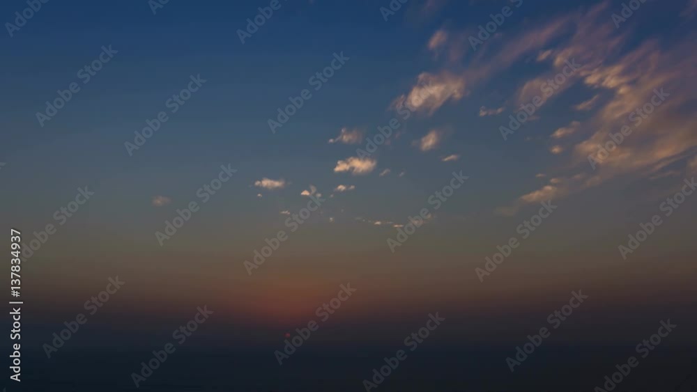 4k time lapse of clouds crossing the amazing sky over the sea or ocean at sunset. transition from day to night. The clouds cross slowly from left to right colored yellow orange purple blue. 4k time lapse of clouds crossing the amazing sky over the sea or ocean at sunset. transition from day to night. The clouds cross slowly from left to right colored yellow orange purple blue.