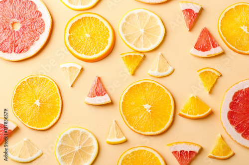 Citrus fruit slices of lemon, orange, grapefruit on yellow background.
