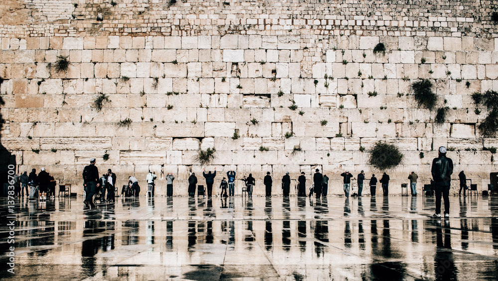 Naklejka premium Jewish people praying at the western wall in the old town of Jerusalem, Israel.