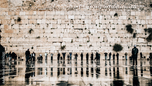 Jewish people praying at the western wall in the old town of Jerusalem, Israel. photo