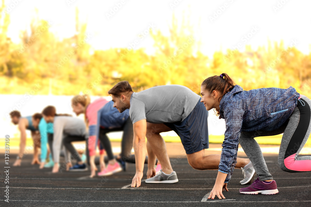 Sportsmen preparing to run at stadium Sportsmen preparing to run at stadium