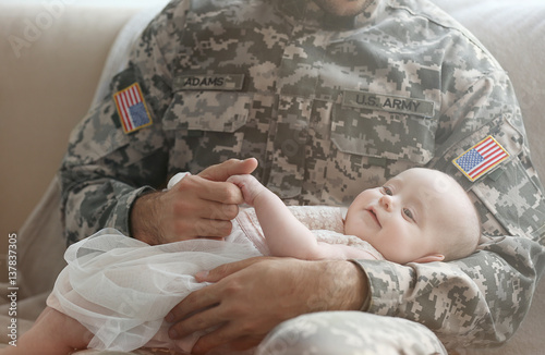 Military father holding his...