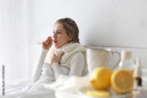 Young ill woman in bed at home