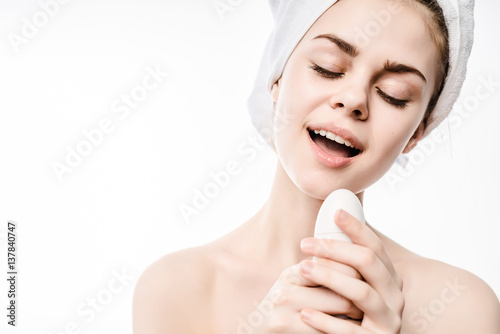 Close up portrait of beauty woman in towels on the head and breasts with electric brush in hands