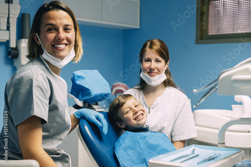 Portrait of dentists and child patient.