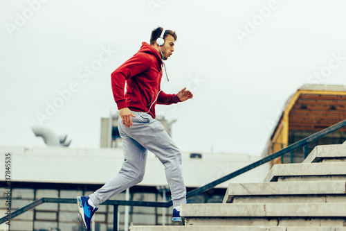 Handsome man running up at stairs