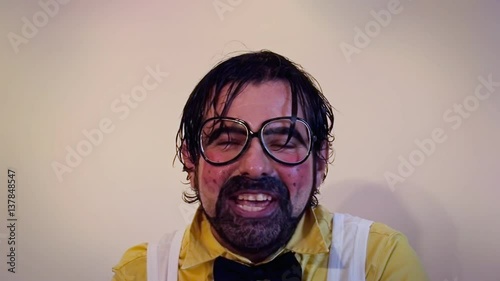 The intense face of a mad salesman doing a tele shopping and staring at the camera with a creepy smile. Funny, humorus, crazy, foolish character.
