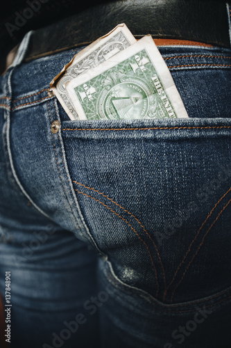 Dollar in the back pocket of jeans teenage girl