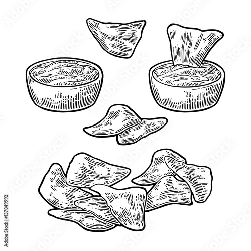 Nachos with a bowl of ketchup or guacamole - mexican food