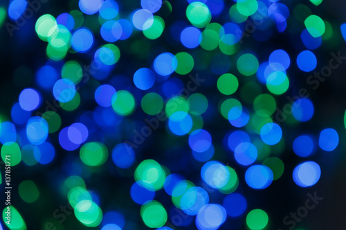 Blurred lights blue background. Glittering christmas effect. Abstract colorful pattern. Shimmering blur spots. Festive design.