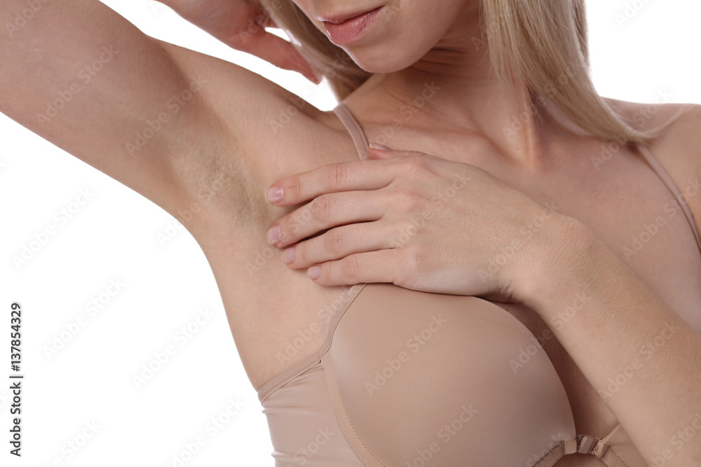 Fototapeta premium Happy smiling beautiful woman showing her Armpit after depilation isolated on white background, female underarm closeup. Waxing, laser hair removal treatment