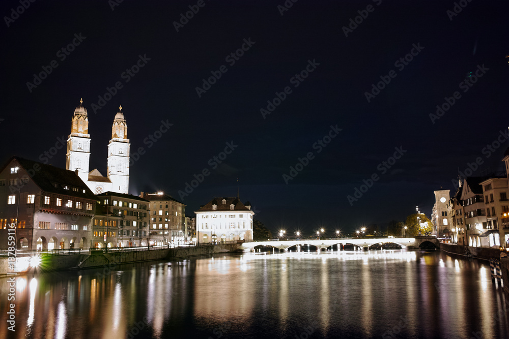 Night panoramic photo of city of Zurich and reflection in Limmat River, Switzerland