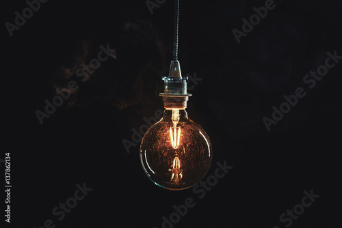 Fototapeta Vintage edison lightbulb on dark background