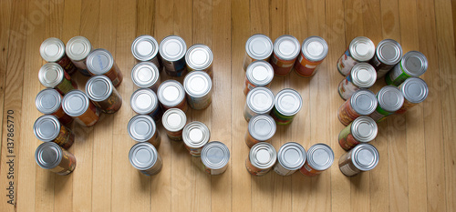 фотографія Cans of food spelling PREP on a wood background, photographed from above