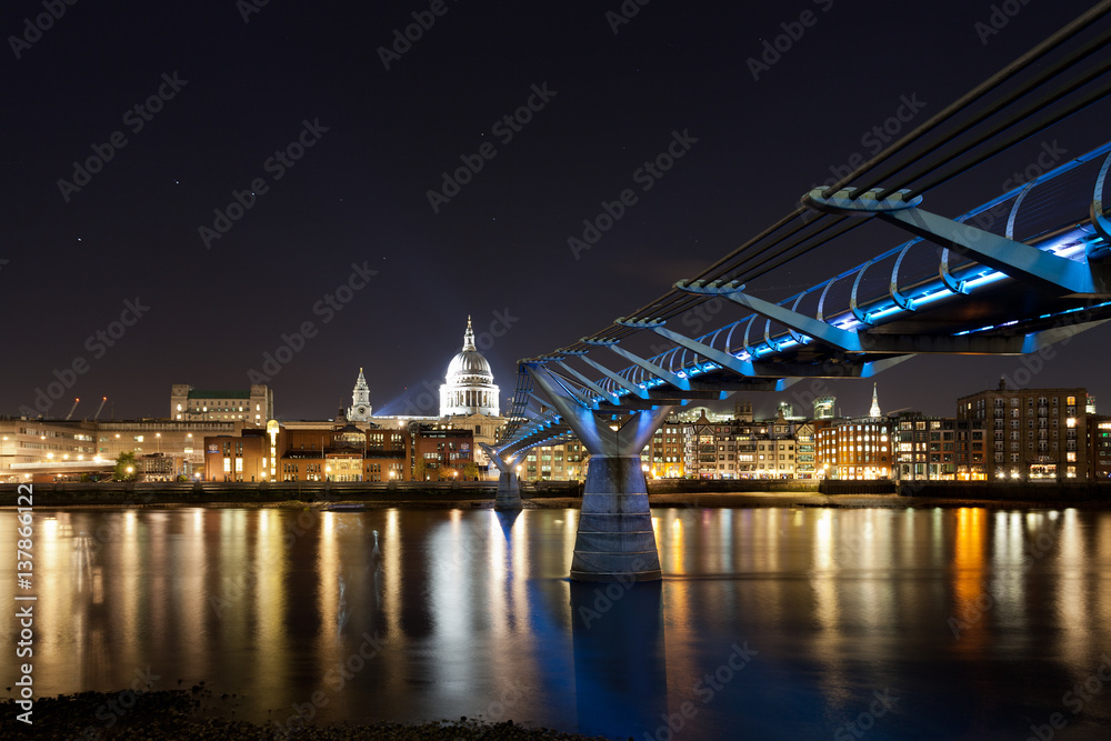 St. Paul's cathedral and the Millennium bridge at night, London, UK