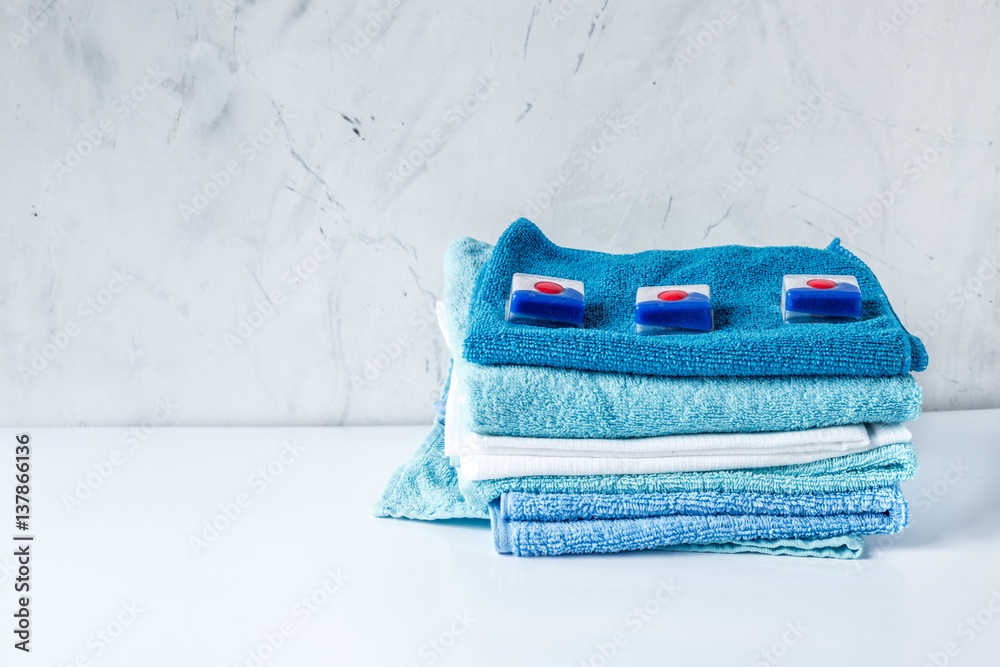 Pile of towels with detergent on laundry background mock up Stock Photo