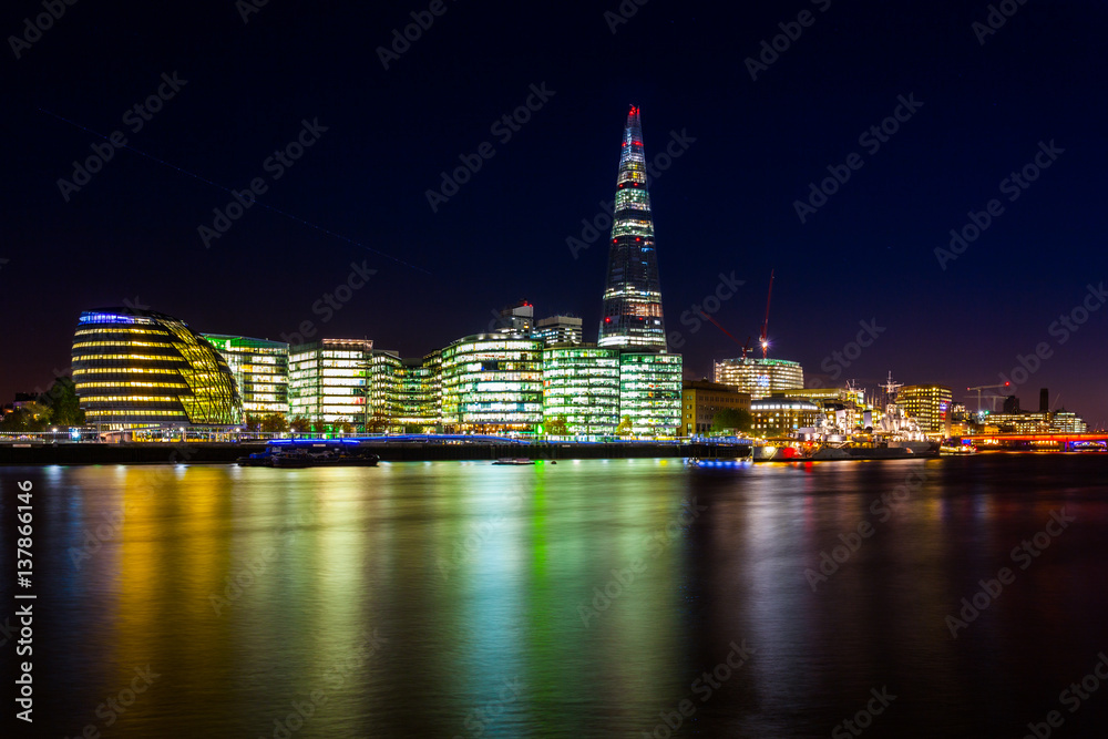 Night photo of City Hall and The Shard from Tower bridge, London, UK