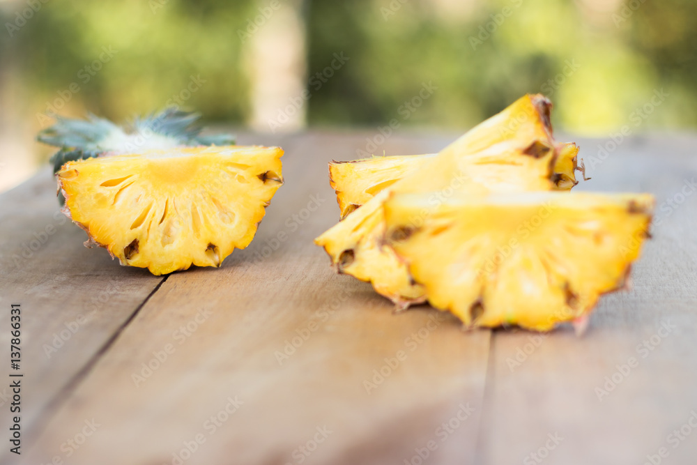 Pineapple slices on wood table , selective focus Pineapple slices on wood table , selective focus