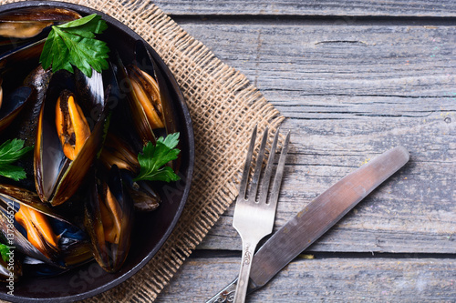 Mussels with parsley in pan