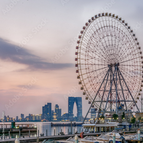 ferris wheel with cityscape in background in Suzhou,China.