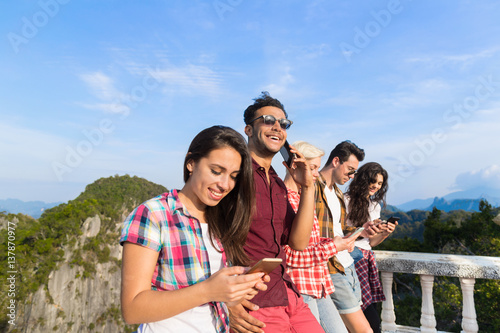 Young People Group In Mountain Using Cell Smart Phone Chatting Online Friends Asian Holiday Summer Vacation Travel