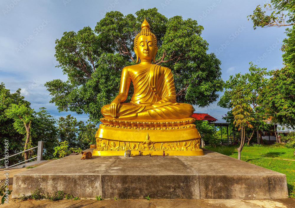 Golden Buddha statue in Khao Chedi Temple on Koh Samui in Thailand.
