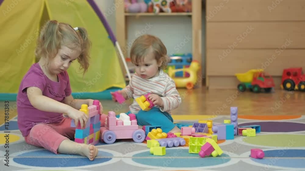 Boy and Girl Build Toy . Children Kid and Baby Play With Blocks. Educational Toys for preschool and kindergarten child. Brother and Sister Playing Boy and Girl Build Toy . Children Kid and Baby Play With Blocks. Educational Toys for preschool and kindergarten child. Brother and Sister Playing