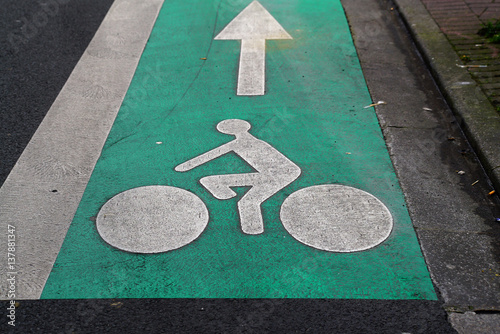 A cyclist sign painted on the road.